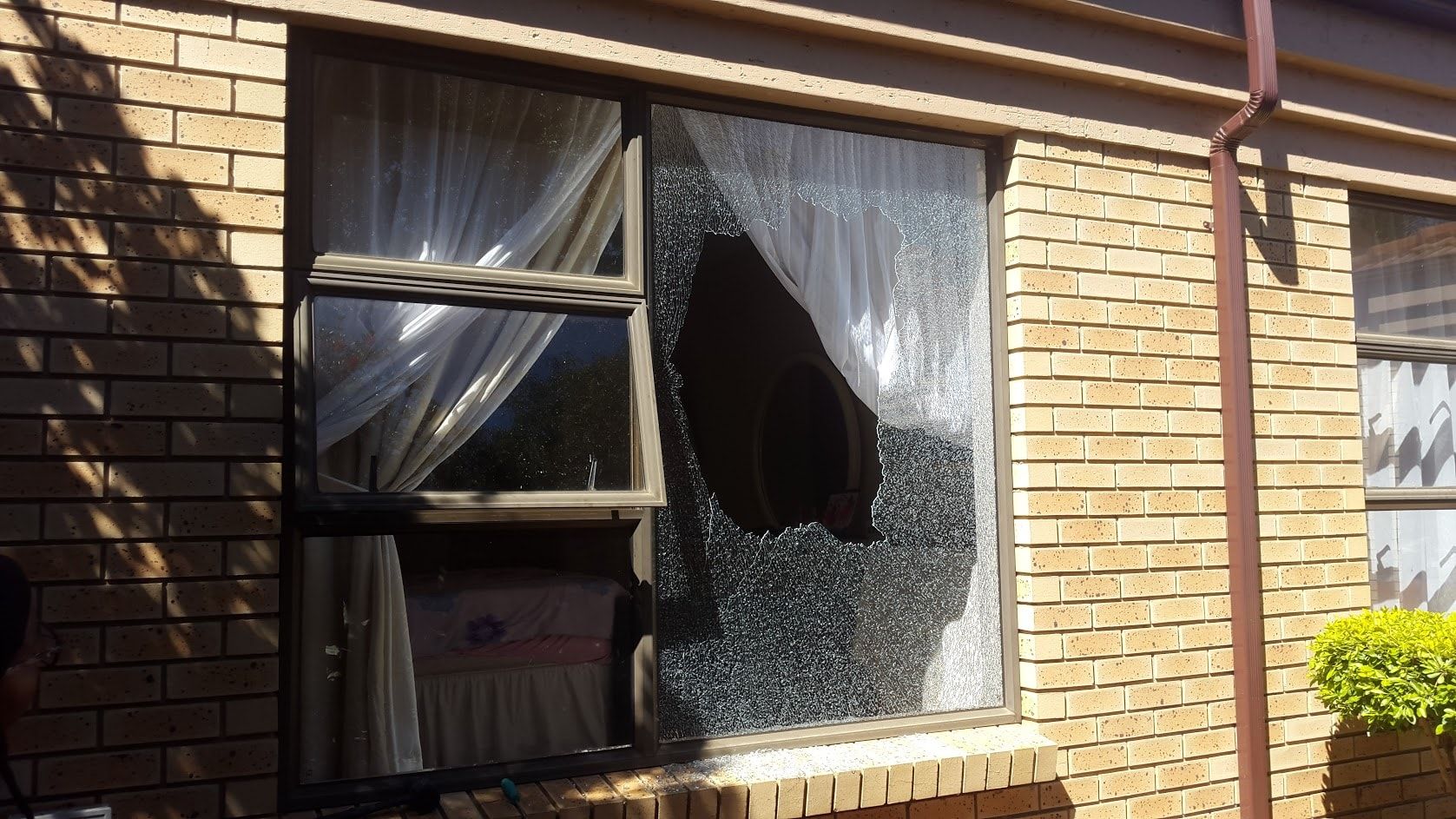 Aluminium window with a broken pane waiting for repair